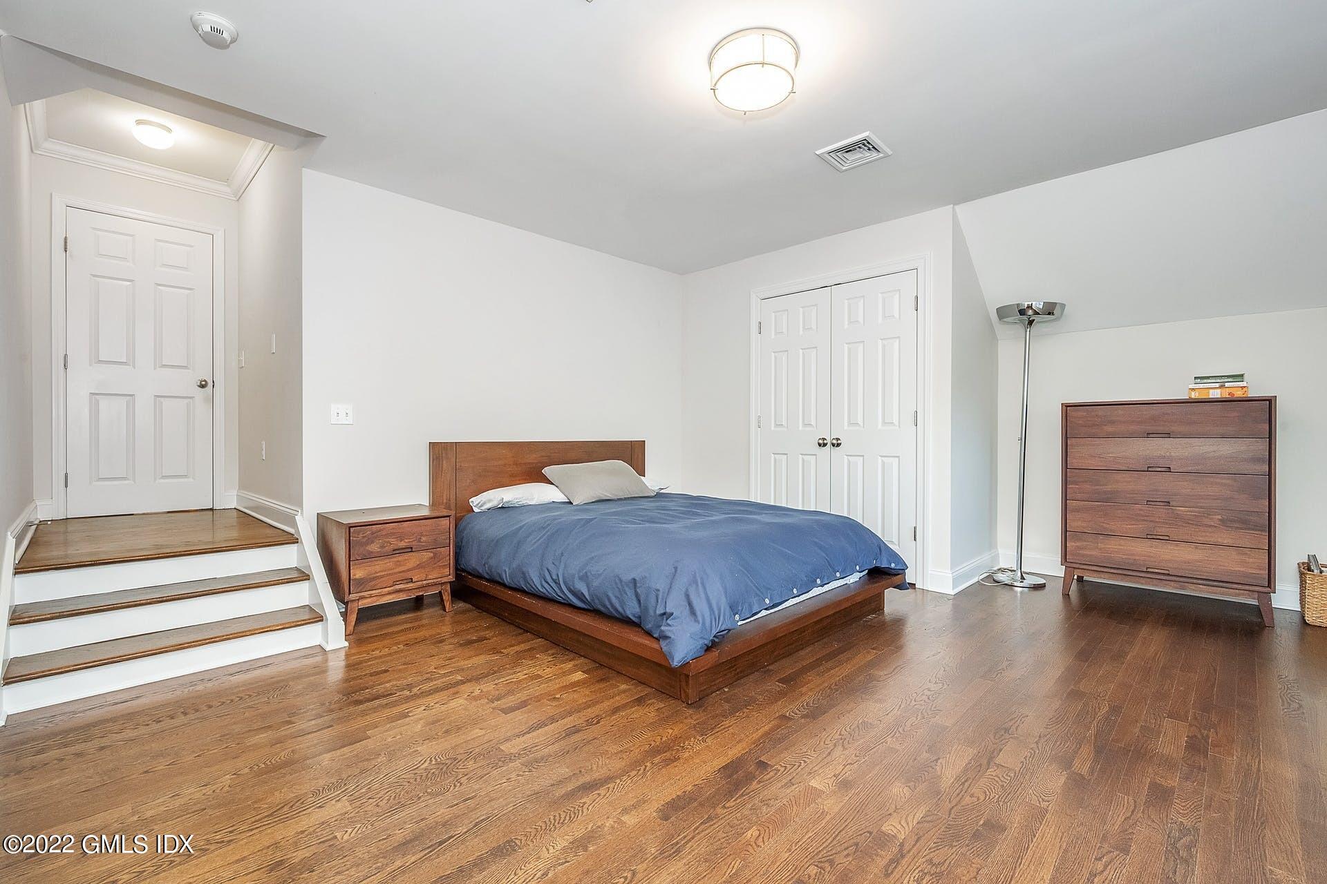 10 Boyd Lane Riverside, CT 06878 - Photo 18 of 30 a bedroom with a bed and wooden floor