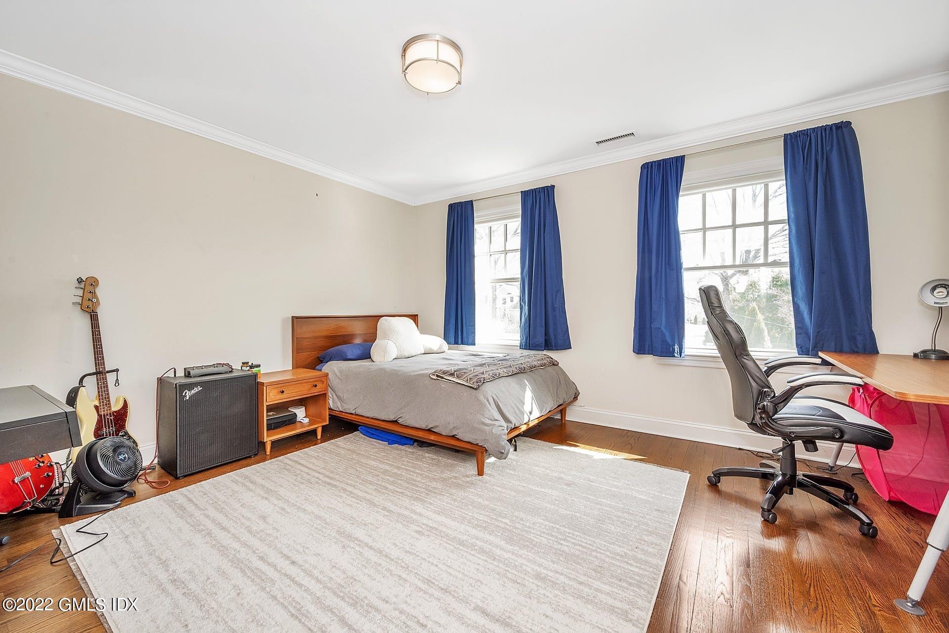 10 Boyd Lane Riverside, CT 06878 - Photo 21 of 30 a spacious bedroom with a bed and wooden floor