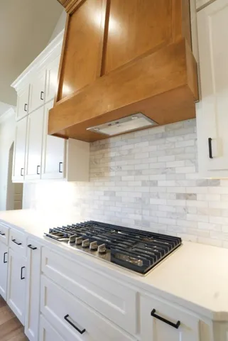 a stove top oven sitting inside of a kitchen