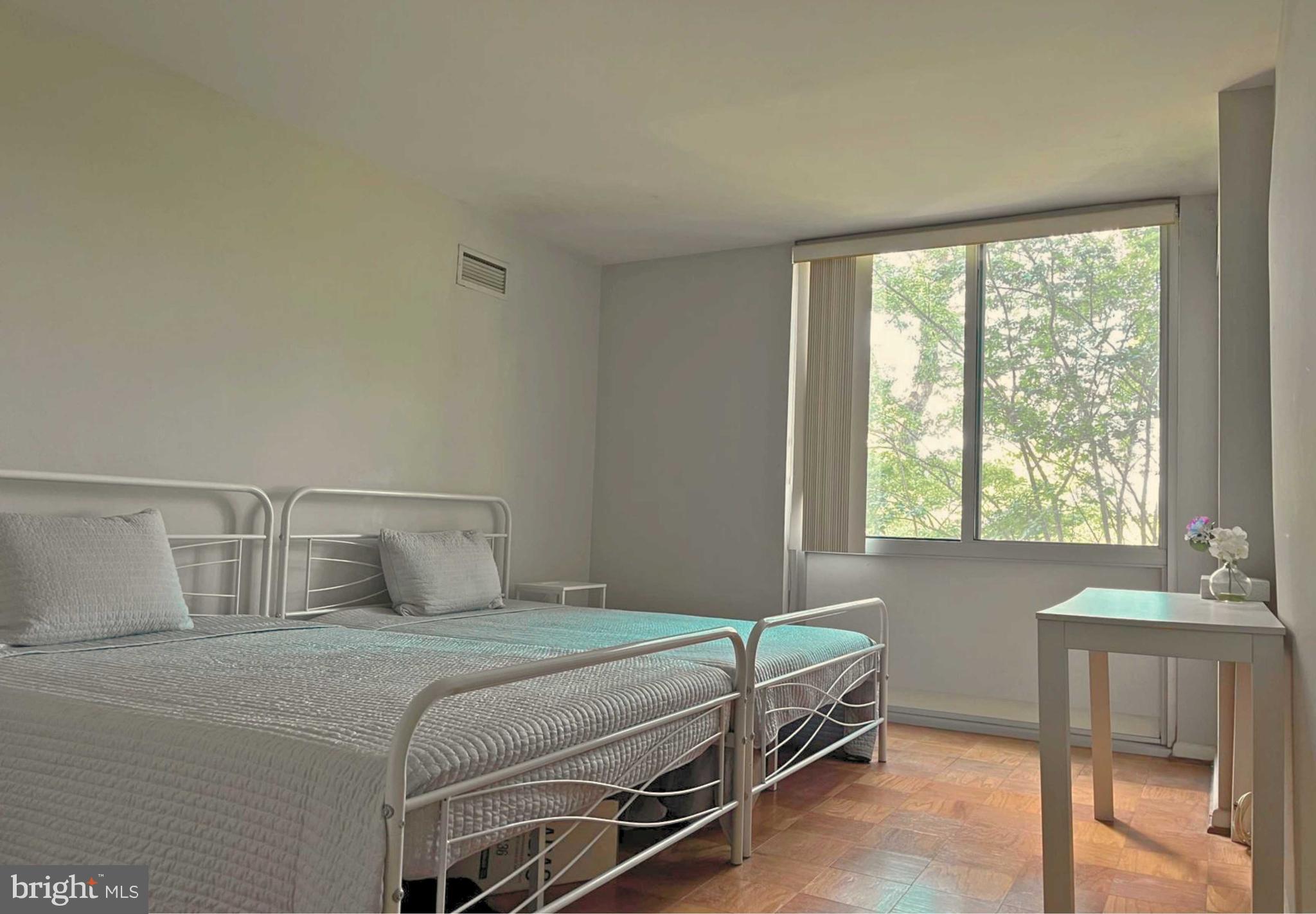 5101 River Road, Unit 405 Bethesda, MD 20816 - Photo 15 of 20 a bedroom with a bed and a table