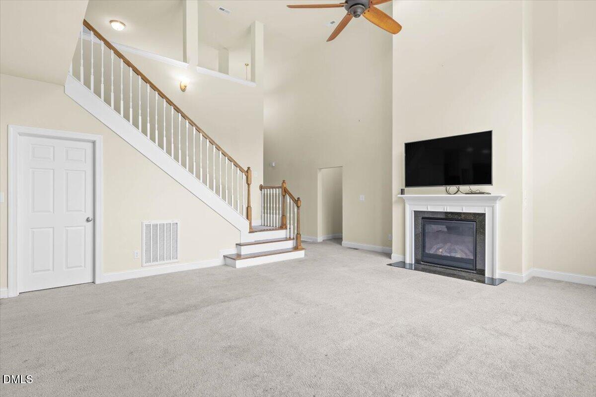 704 Haw River Hopedale Road Burlington, NC 27217 - Photo 13 of 49 a view of an empty room with fireplace and a window