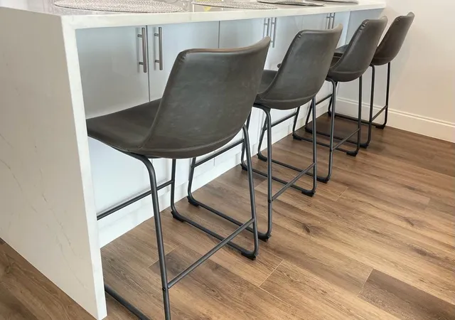a living room with table chairs and wooden floor
