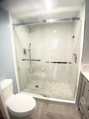 a bathroom with a shower and a toilet