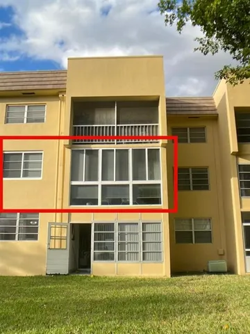a view of a house with a yard and a garage