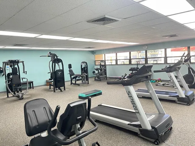 a room with gym equipment and a large window