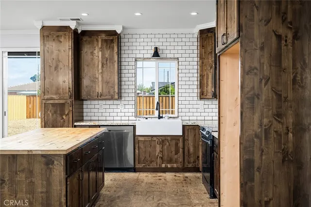 a kitchen with a sink refrigerator and cabinets