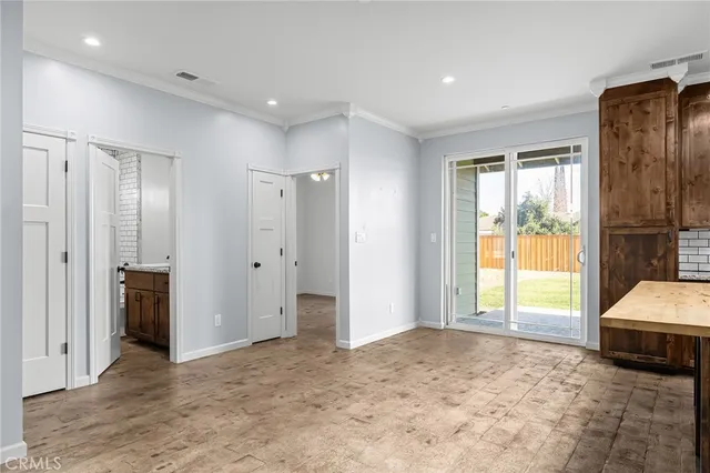 a view of a bedroom with a bed and large windows