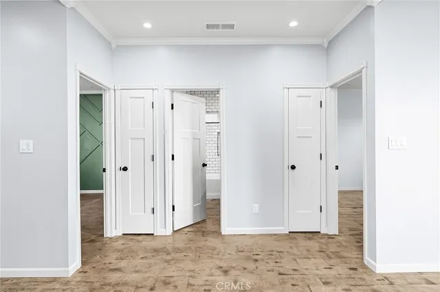 a view of a hallway with wooden shelves