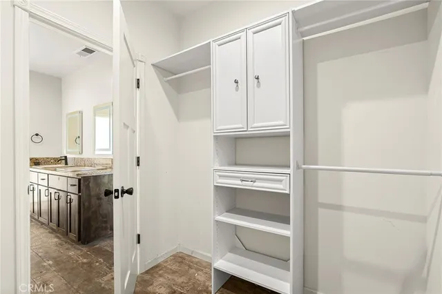 a bathroom with a granite countertop tub sink and mirror