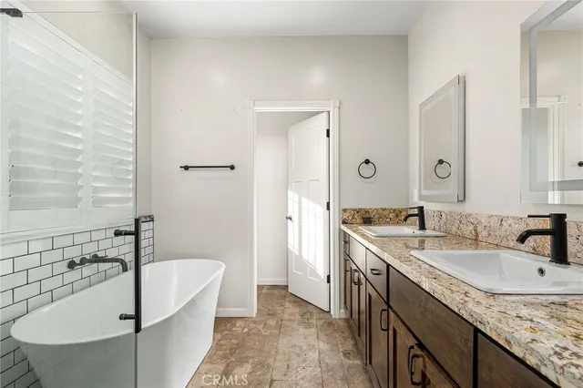 a white bath tub sitting in a bathroom next to a window
