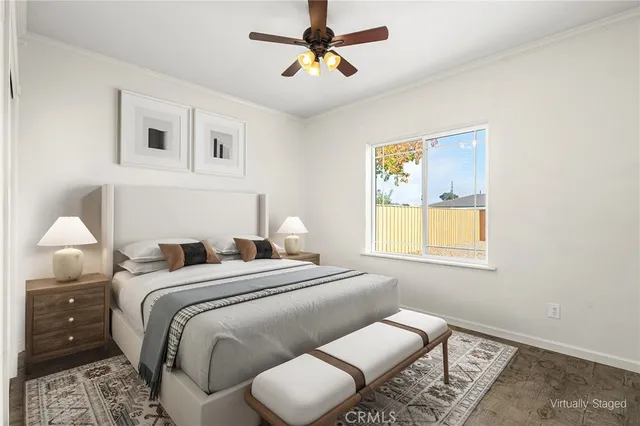 an empty room with a window and a ceiling fan