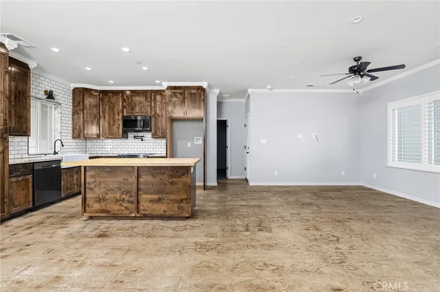 a large kitchen with kitchen island a sink stainless steel appliances and cabinets