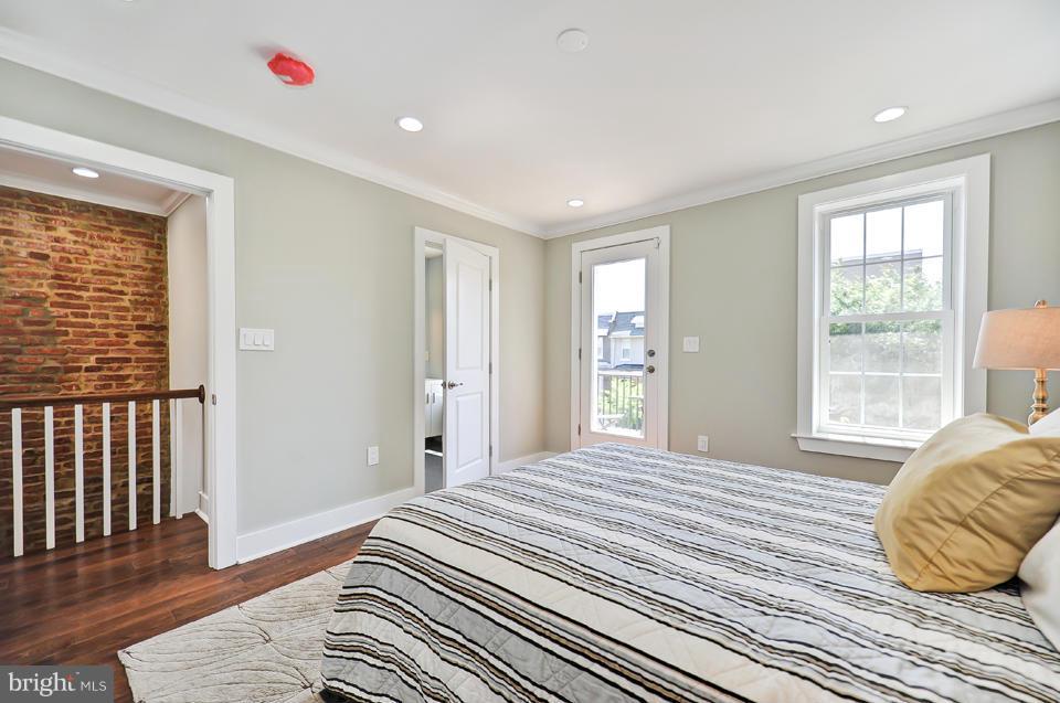 1110 Orren Street Northeast Washington, DC 20002 - Photo 13 of 30 a bedroom with a bed and wooden floor