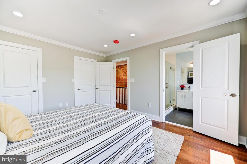 1110 Orren Street Northeast Washington, DC 20002 - Photo 14 of 30 a bedroom with a bed and wooden floor