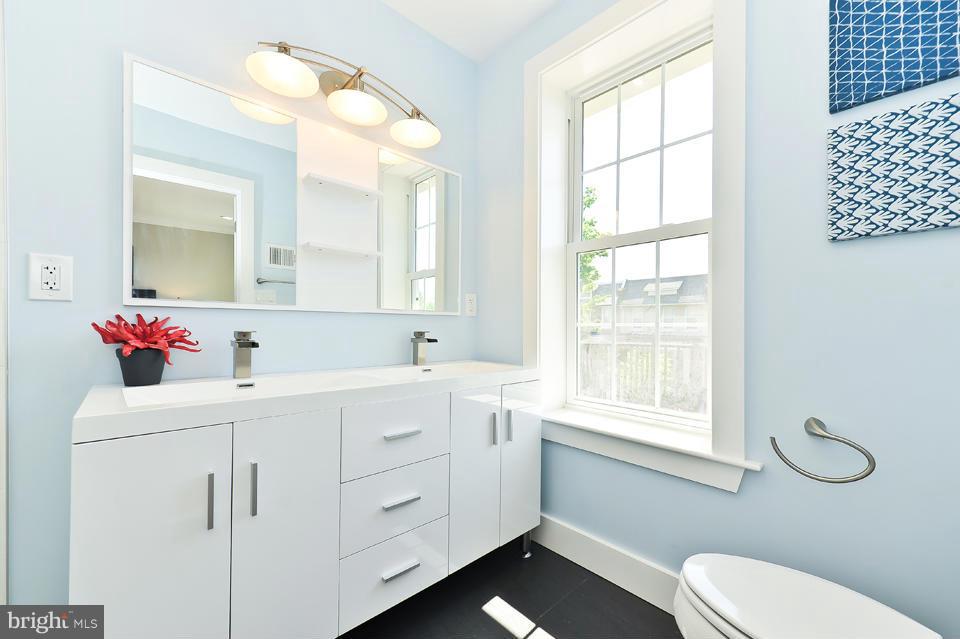 1110 Orren Street Northeast Washington, DC 20002 - Photo 15 of 30 a bathroom with a sink vanity mirror and toilet