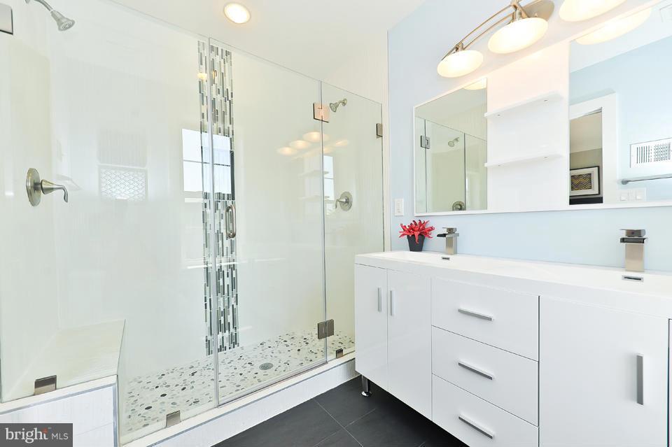 1110 Orren Street Northeast Washington, DC 20002 - Photo 16 of 30 a bathroom with a shower sink and mirror