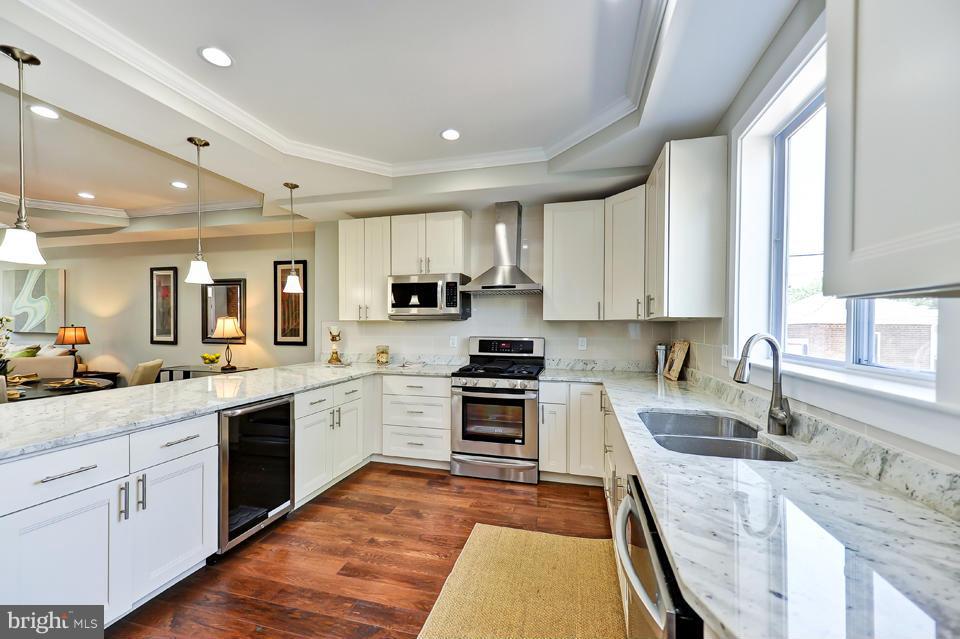 1110 Orren Street Northeast Washington, DC 20002 - Photo 10 of 30 a large kitchen with stainless steel appliances granite countertop a sink and cabinets