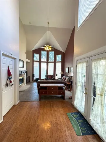 a living room with a balcony furniture and a chandelier