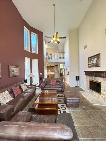 a living room with furniture a fireplace and a chandelier