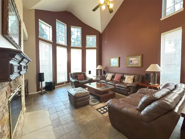 a living room with furniture large window and a flat screen tv