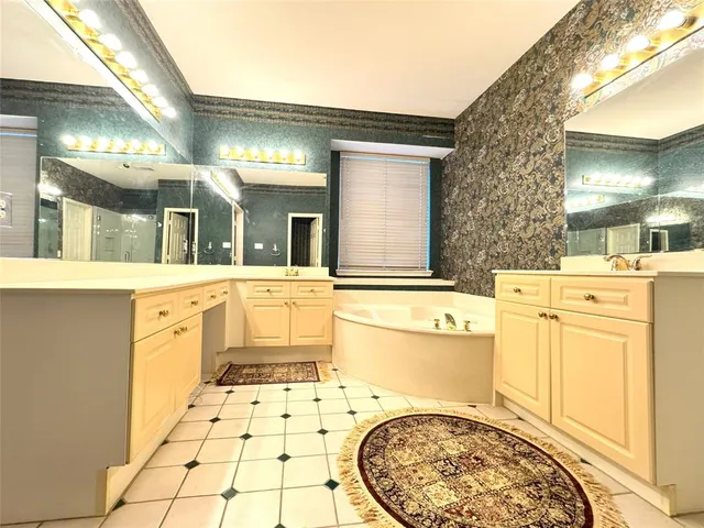 a bathroom with a sink a mirror and a bathtub