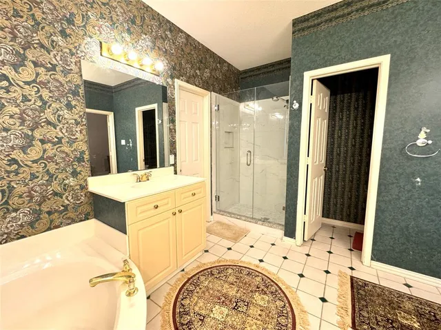 a bathroom with a bathtub sink and mirror
