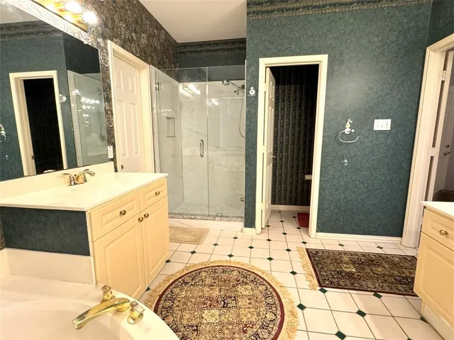 a spacious bathroom with a tub shower and sink