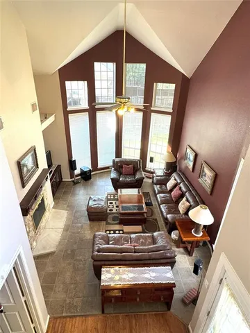 a living room with furniture and a floor to ceiling window