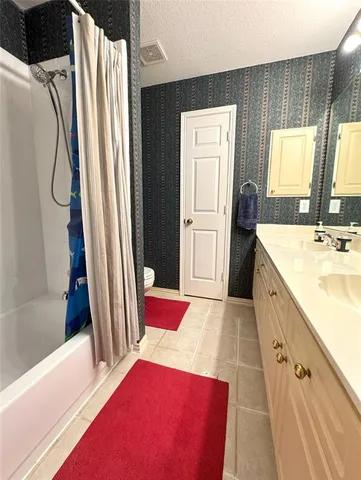 a en suite bathroom with a sink and a large mirror