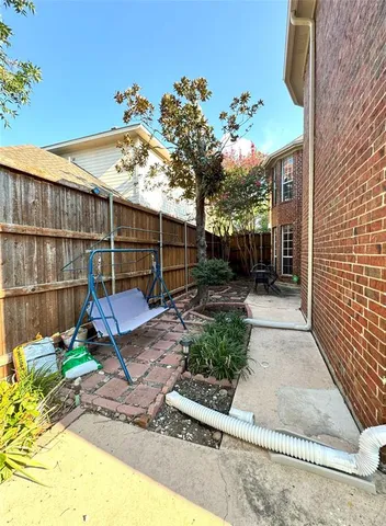 a view of a chair and table in backyard