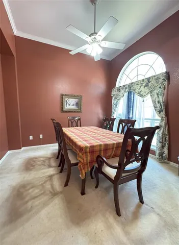 a dining room with a wooden table and chairs