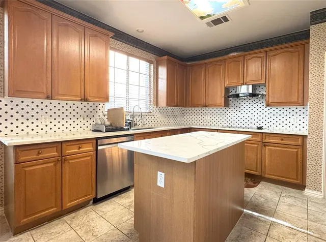 a kitchen with a sink cabinets and window