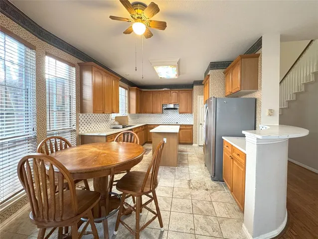 a dining room with furniture and a kitchen