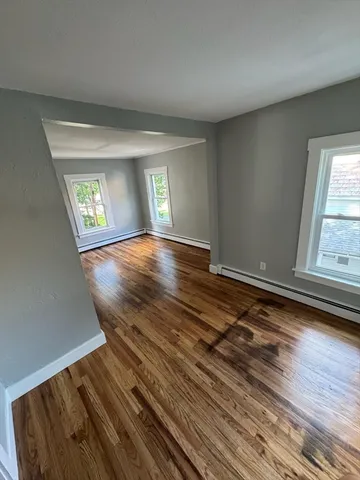 wooden floor in an empty room with a window