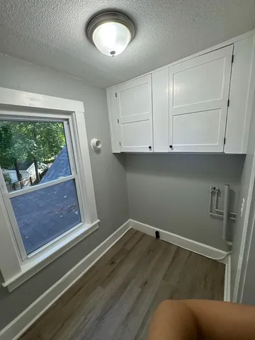 a view of room with window and cabinet