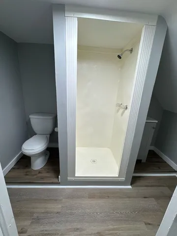 a bathroom with a toilet and a mirror