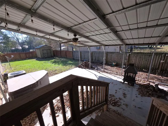 a backyard of a house with table and chairs
