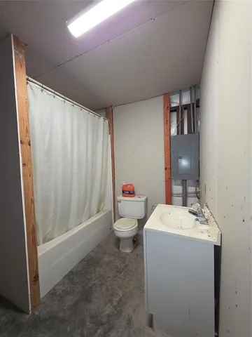 a bathroom with a sink a toilet and shower curtain