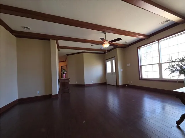 a view of a livingroom with wooden floor and window