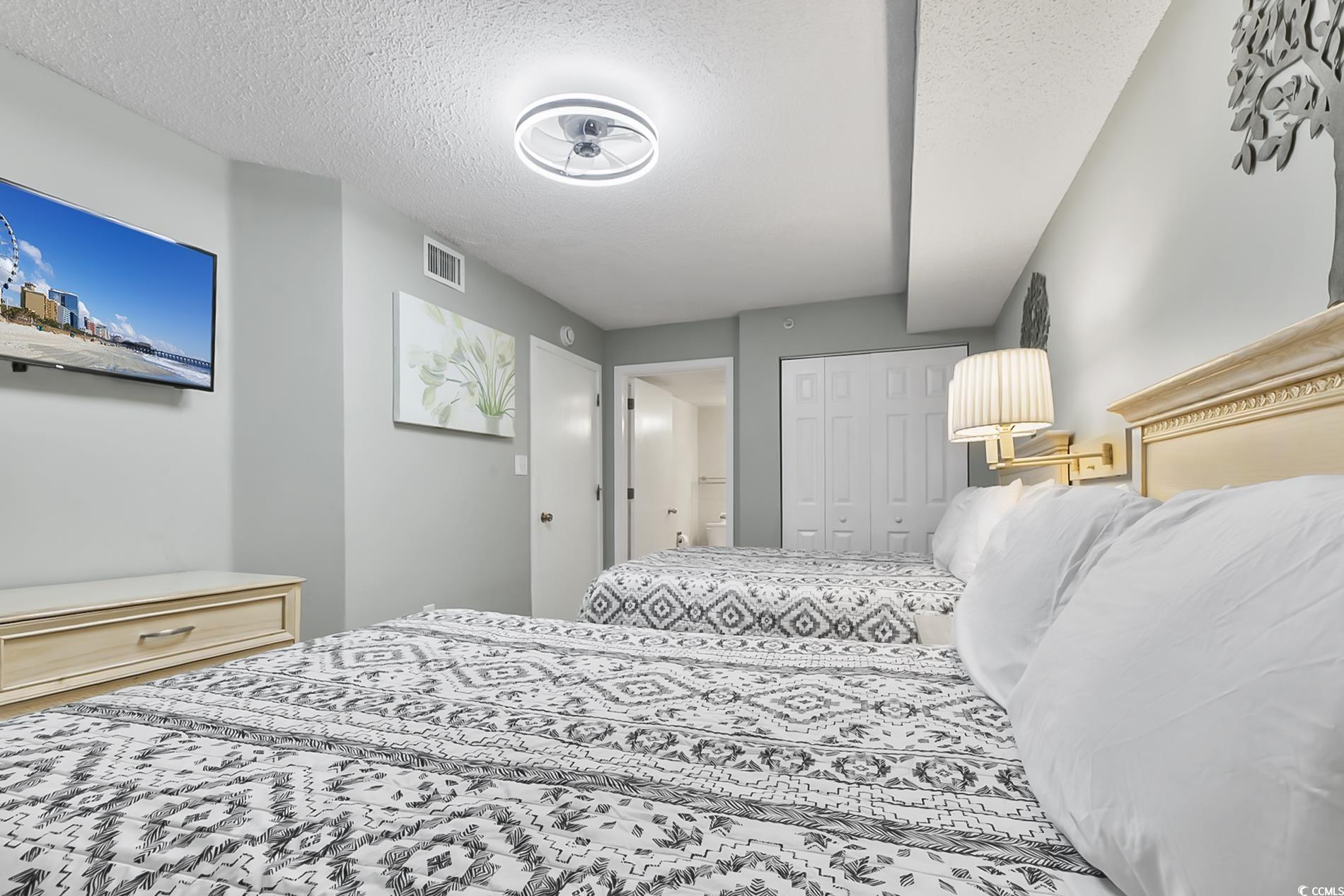 205 74th Avenue North, Unit 708 Myrtle Beach, SC 29572 - Photo 20 of 38 Bedroom featuring a textured ceiling and a closet
