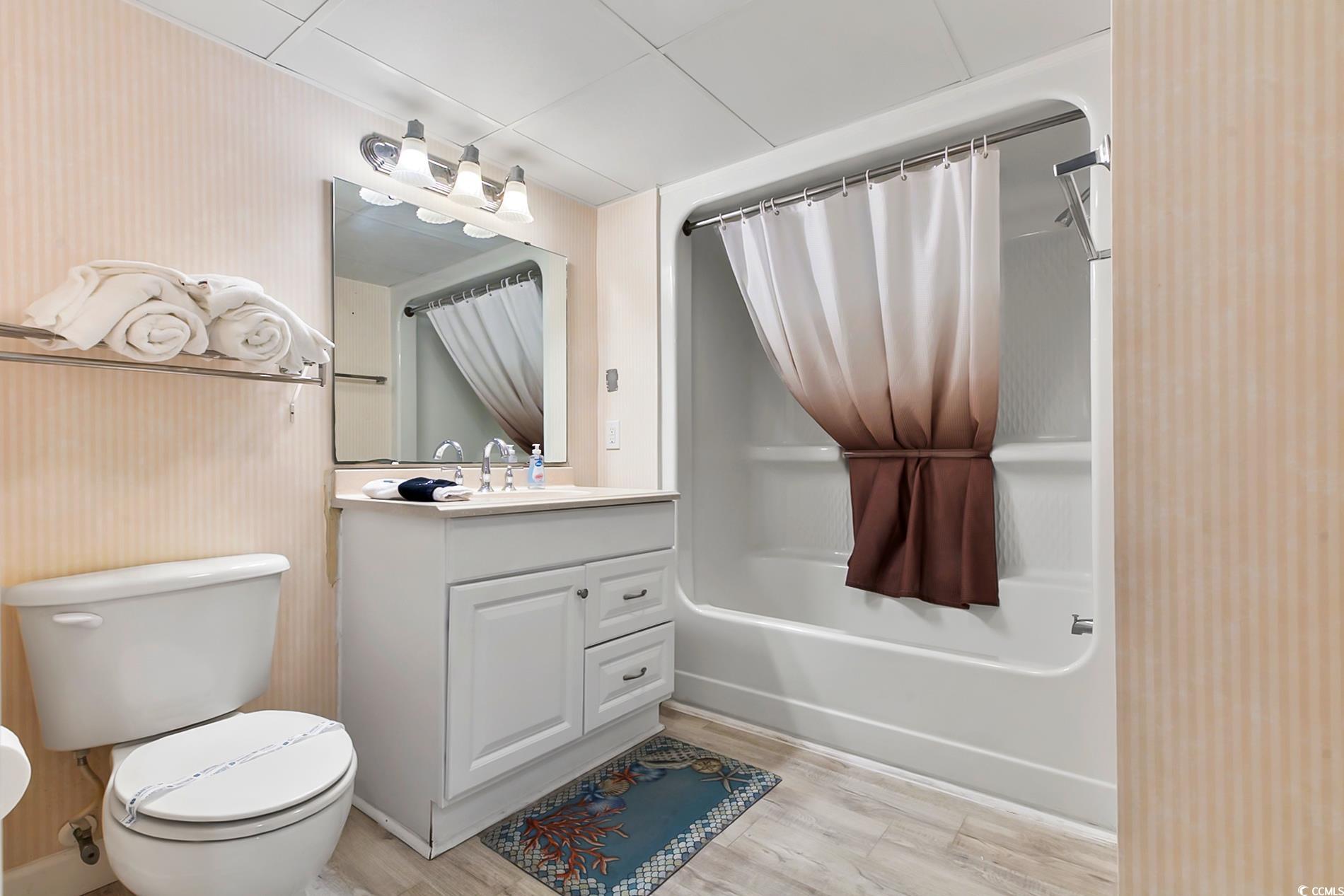 205 74th Avenue North, Unit 708 Myrtle Beach, SC 29572 - Photo 21 of 38 Full bathroom featuring shower / tub combo with curtain, vanity, and light wood-style flooring