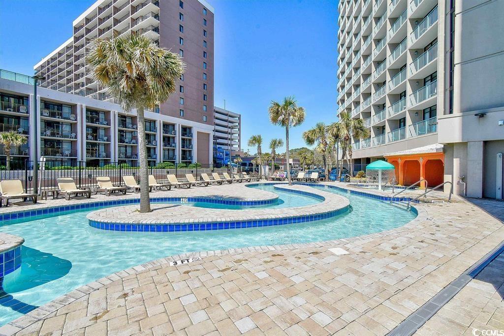 205 74th Avenue North, Unit 708 Myrtle Beach, SC 29572 - Photo 33 of 38 Community pool with a patio