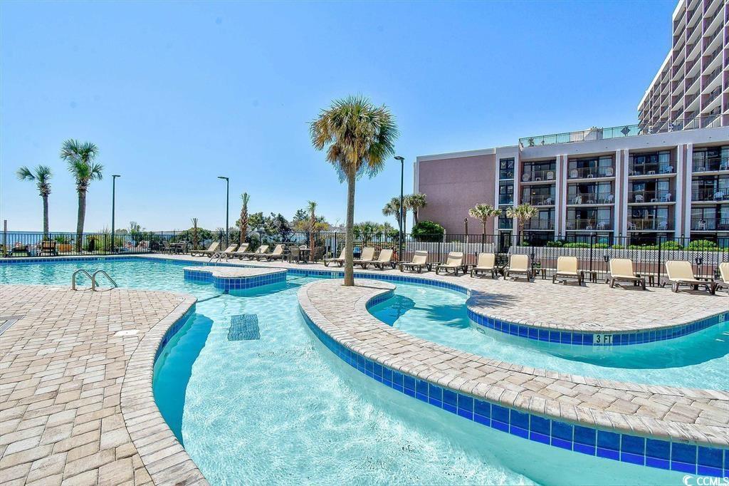 205 74th Avenue North, Unit 708 Myrtle Beach, SC 29572 - Photo 34 of 38 Community pool featuring a patio