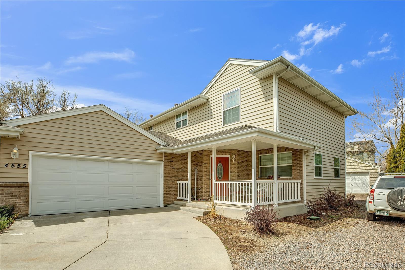 4545 Simms Court Wheat Ridge, CO 80033 - Photo 4 of 28 a front view of a house with a garage