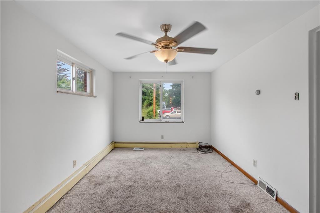 1420 Homestead Road Verona, PA 15147 - Photo 12 of 34 an empty room with windows and fan