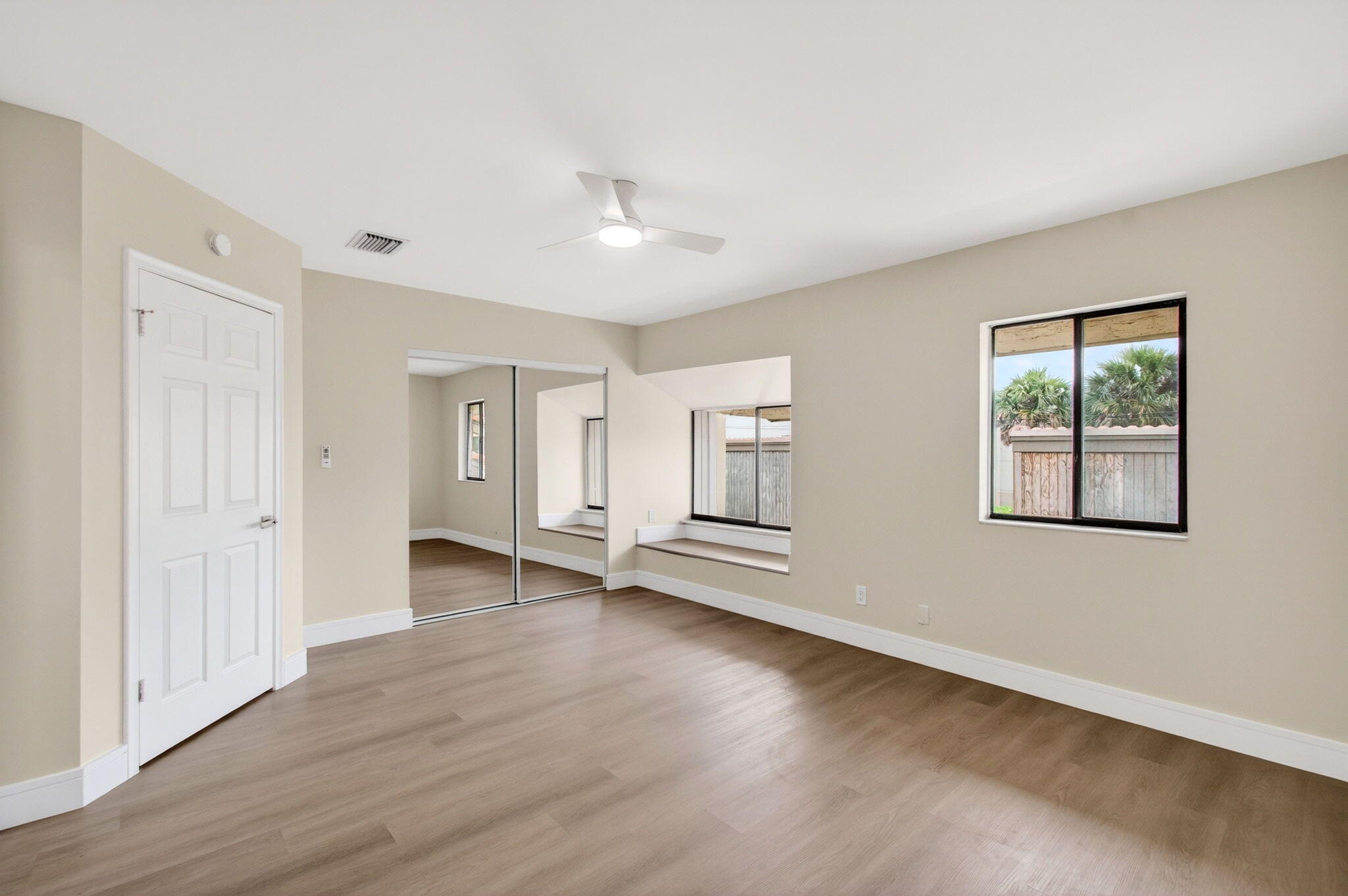 1330 Northwest 13th Street, Unit 12 Boca Raton, FL 33486 - Photo 37 of 52 an empty room with wooden floor and windows