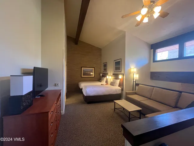 a bedroom with a bed window and couch