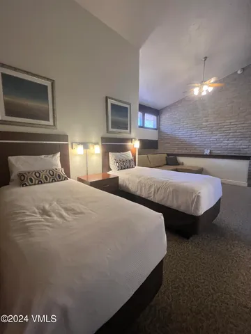 a spacious bedroom with two beds and a couch