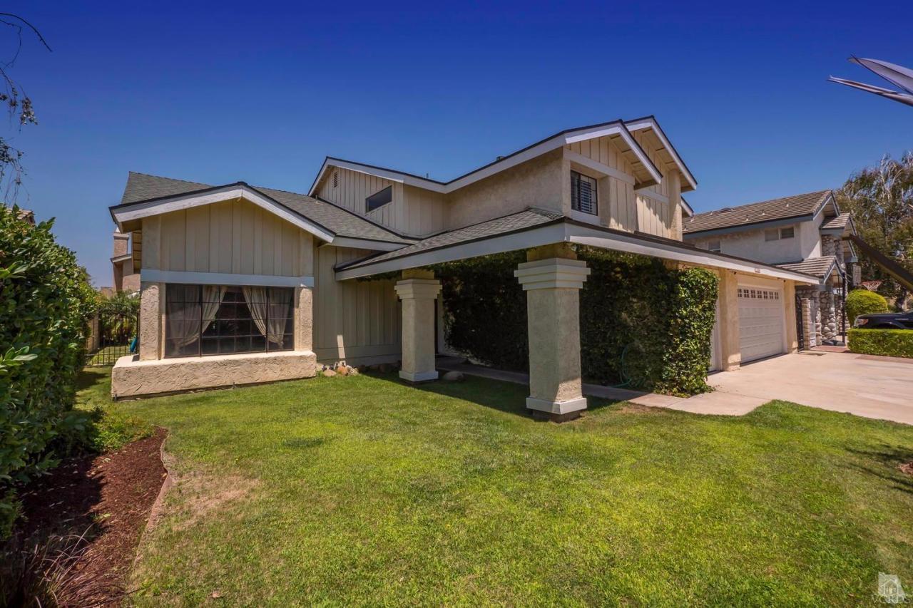 11529 East Buttercreek Road Moorpark, CA 93021 - Photo 2 of 36 a front view of a house with yard and garage