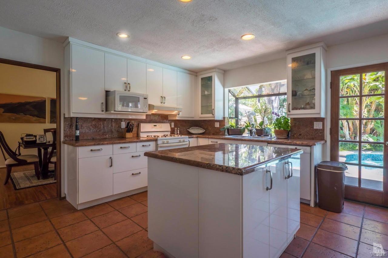 11529 East Buttercreek Road Moorpark, CA 93021 - Photo 12 of 36 a kitchen with stainless steel appliances granite countertop a stove a sink and a microwave